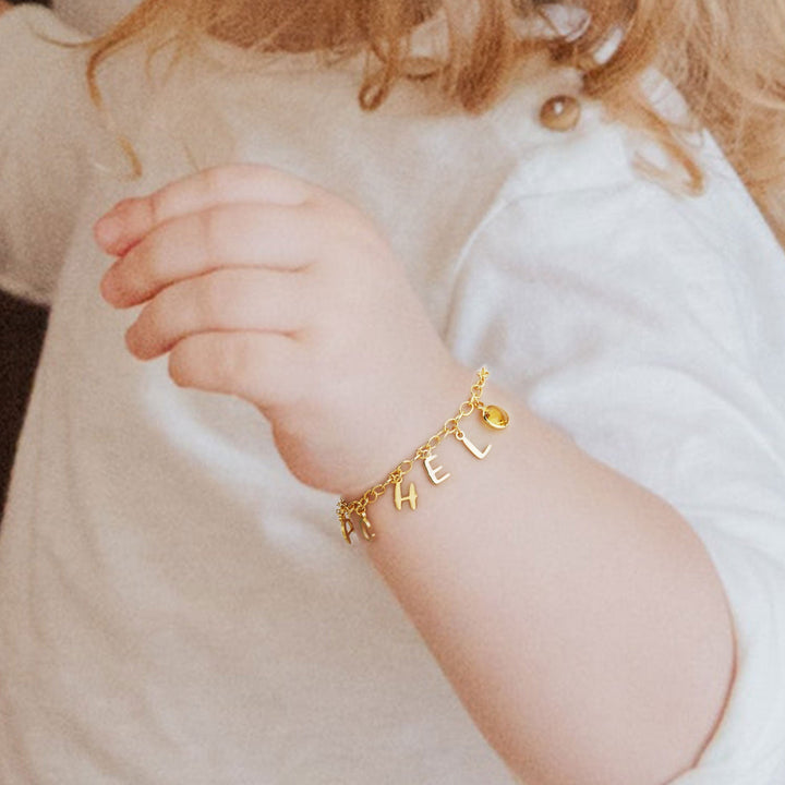 Gold Personalized Letters and Birthstone Pendant Bracelet Worn on Baby Girls Hand
