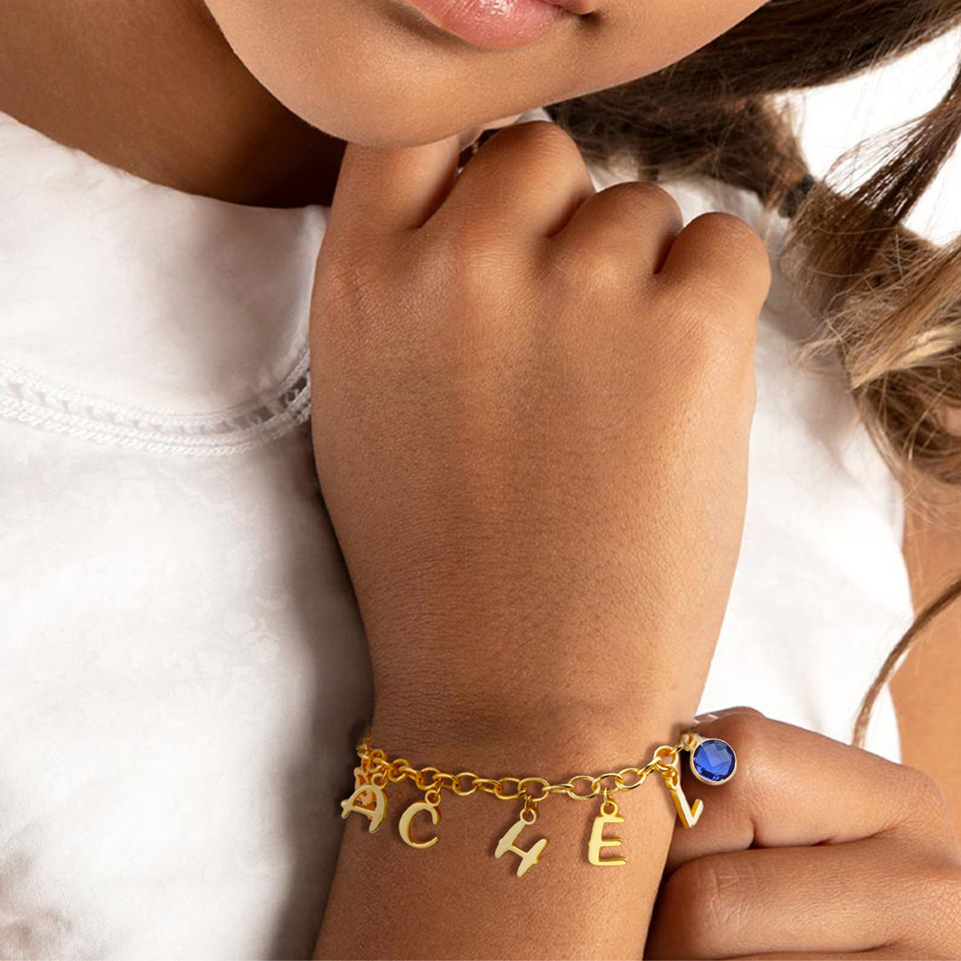 Gold Personalized Letters and Birthstone Pendant Bracelet Worn on Girls Hand