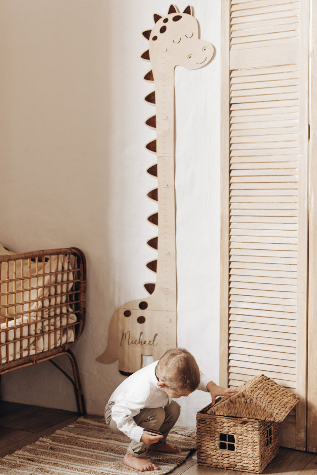 Little boy is using a dinosaur growth chart height ruler - 3